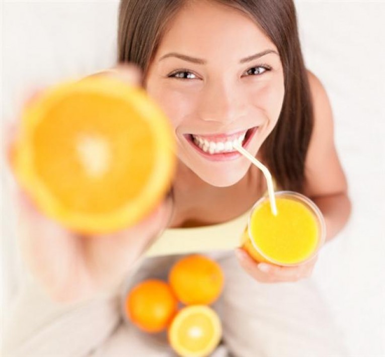 woman drinking orange juice